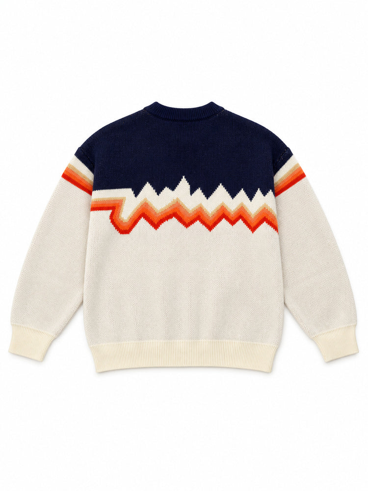 Back flat lay of the cream and navy knit sweater showing continuous orange zigzag bands.