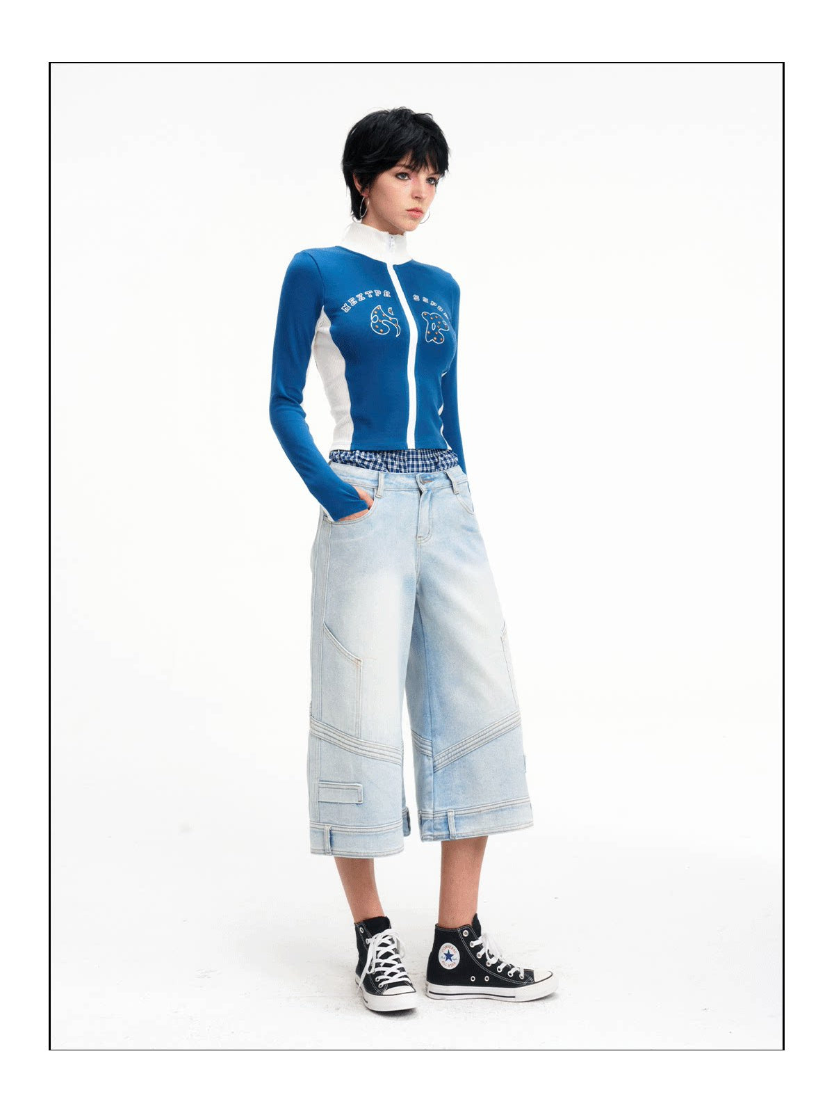 Full-length front studio view of the light-wash cropped jeans