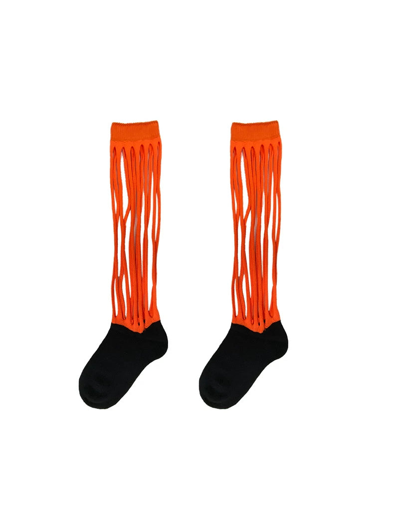 NEXT PASSPORT MULTIPASS cutout knee-high socks — orange-and-black pair shown alone against a white background.
