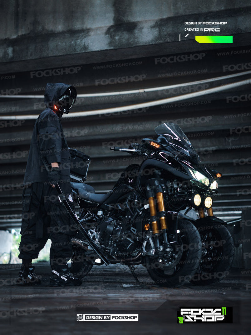 FOCKSHOP VOID black illuminated tactical mask — full-length side modeled view beside a motorcycle
