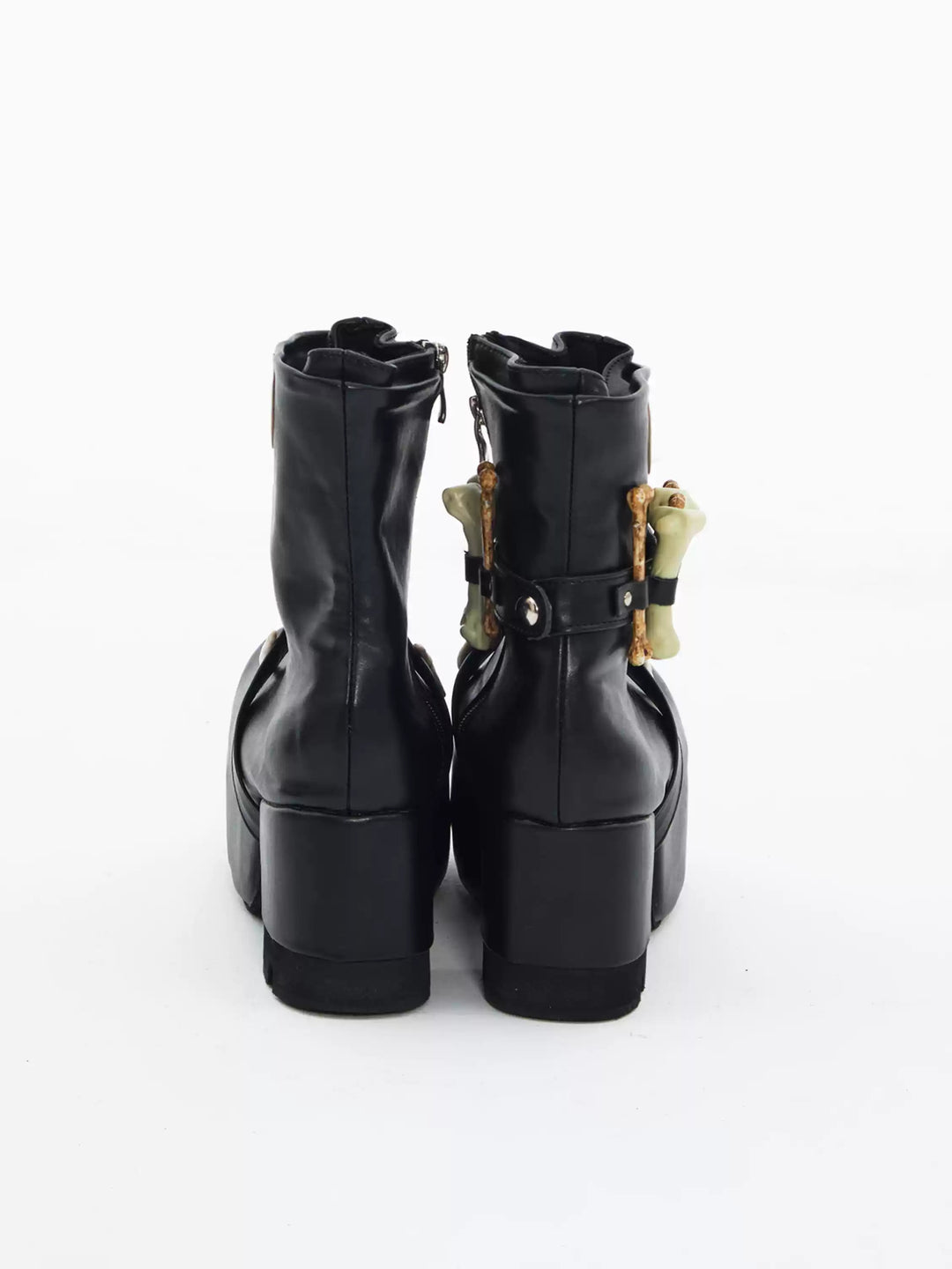 EMBRYO BONE LIFT detachable-bone platform boots — back view of the black pair showing shaft seams and block heels