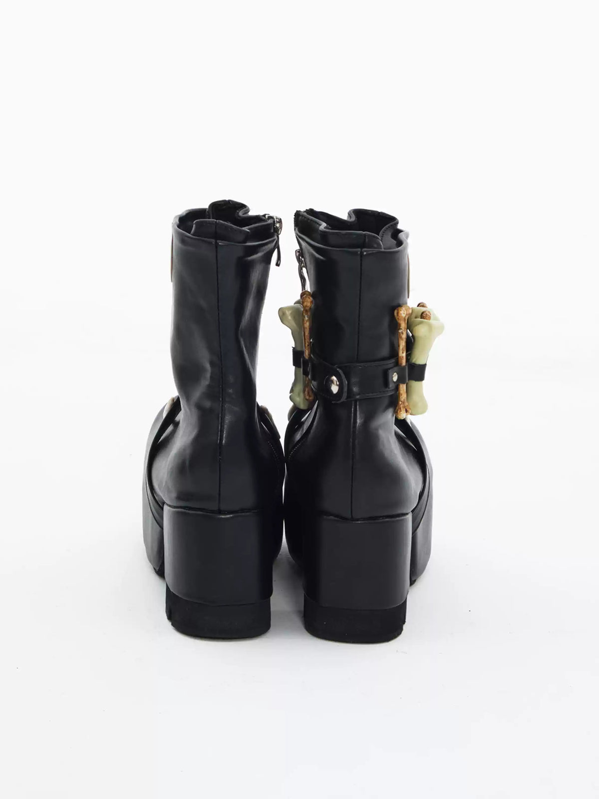 EMBRYO BONE LIFT detachable-bone platform boots — back view of the black pair showing shaft seams and block heels