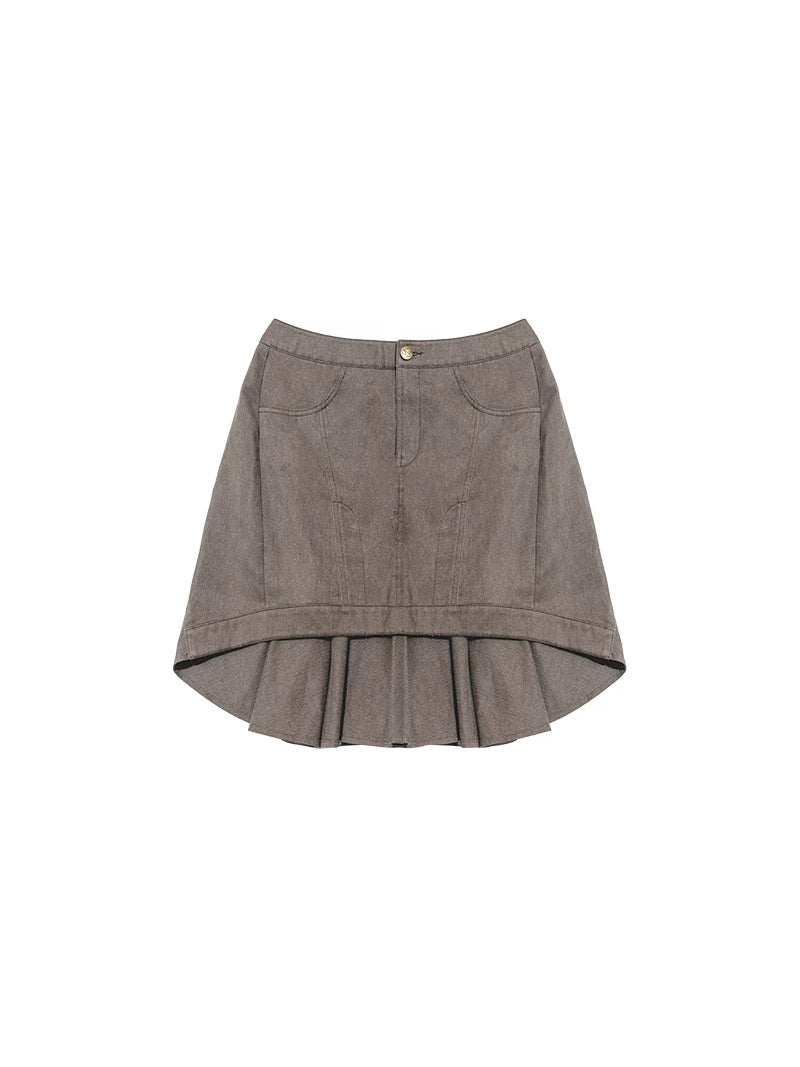 NEXT PASSPORT gray asymmetric cotton mini skirt — garment-only flat lay showing the flat front and pleated back.