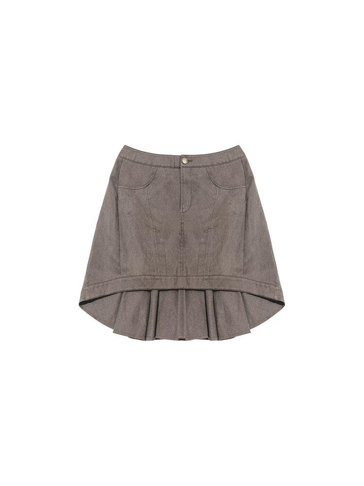 NEXT PASSPORT gray asymmetric cotton mini skirt — garment-only flat lay showing the flat front and pleated back.
