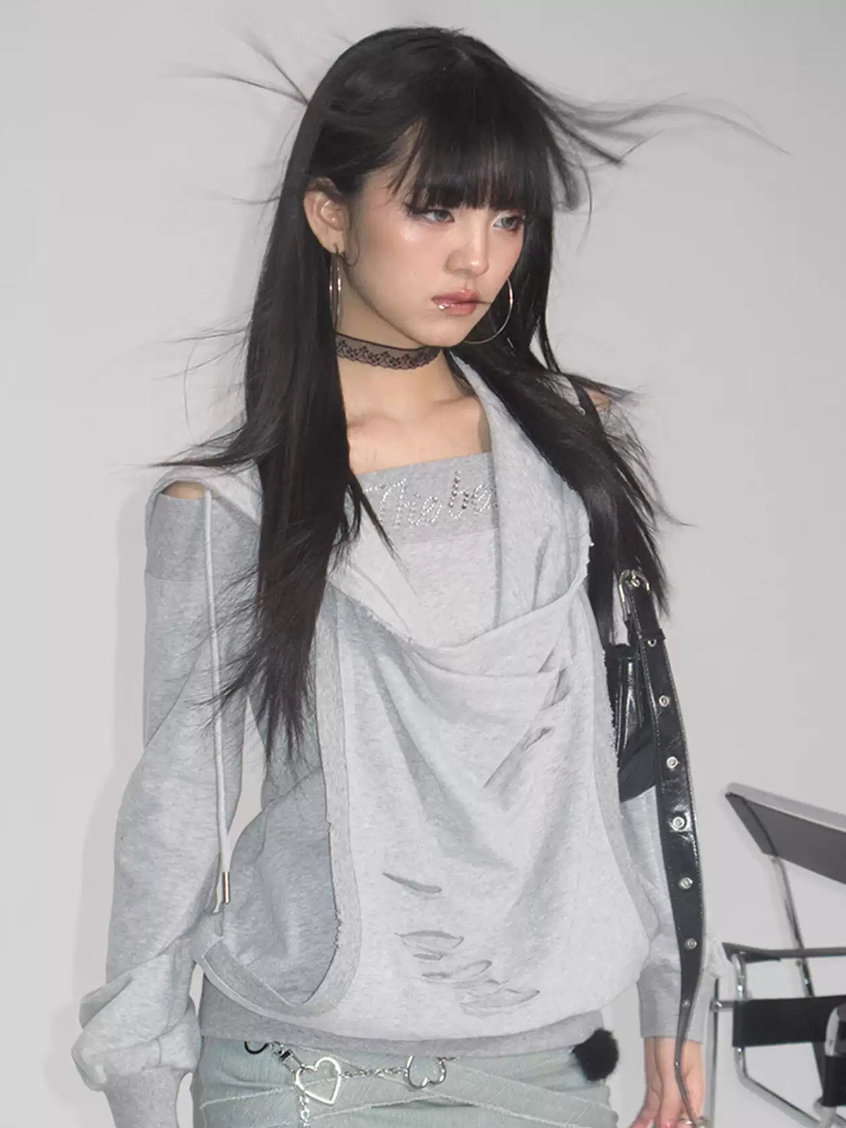 Modeled studio view of the gray distressed layered hoodie