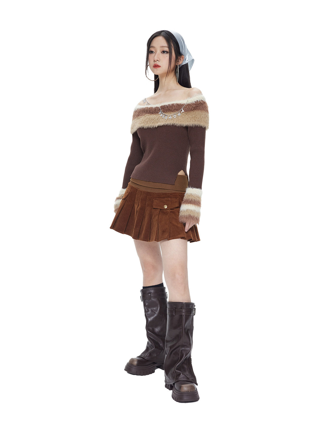 Model wearing the chocolate brown corduroy pleated mini skirt, full view