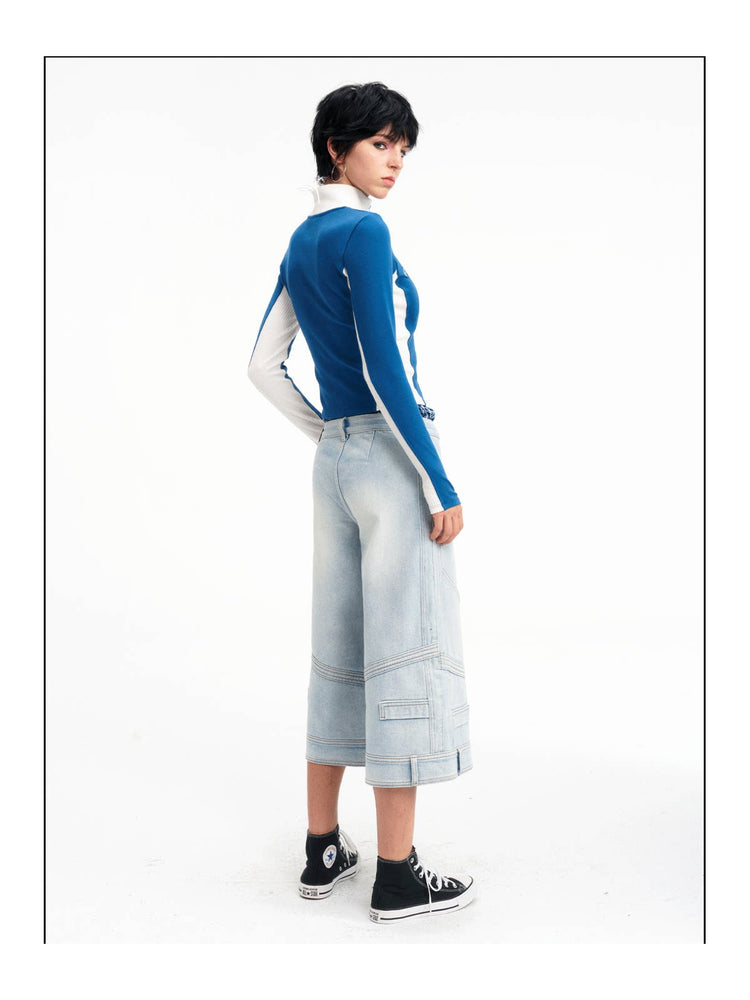 Rear three-quarter studio view of the light-blue cropped jeans