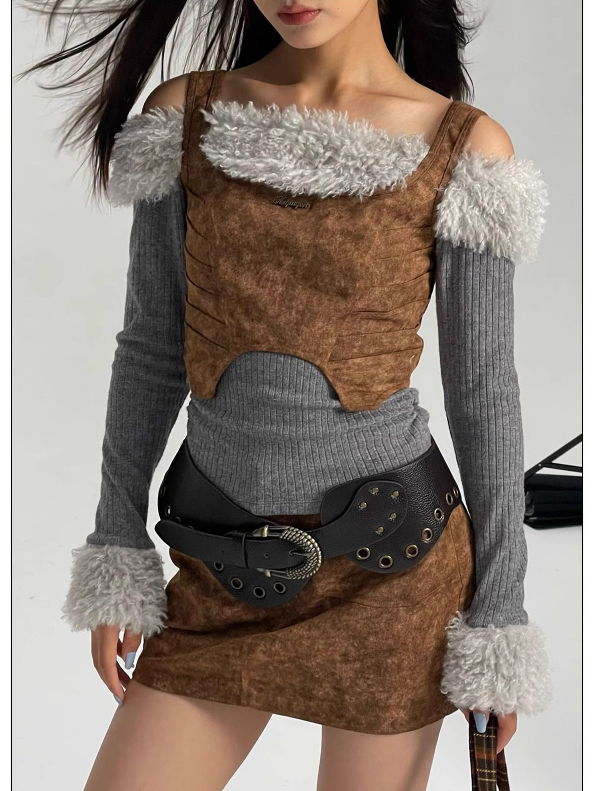 NEXT PASSPORT wasteland-brown shark-pleat vest and mini skirt — full-length editorial view
