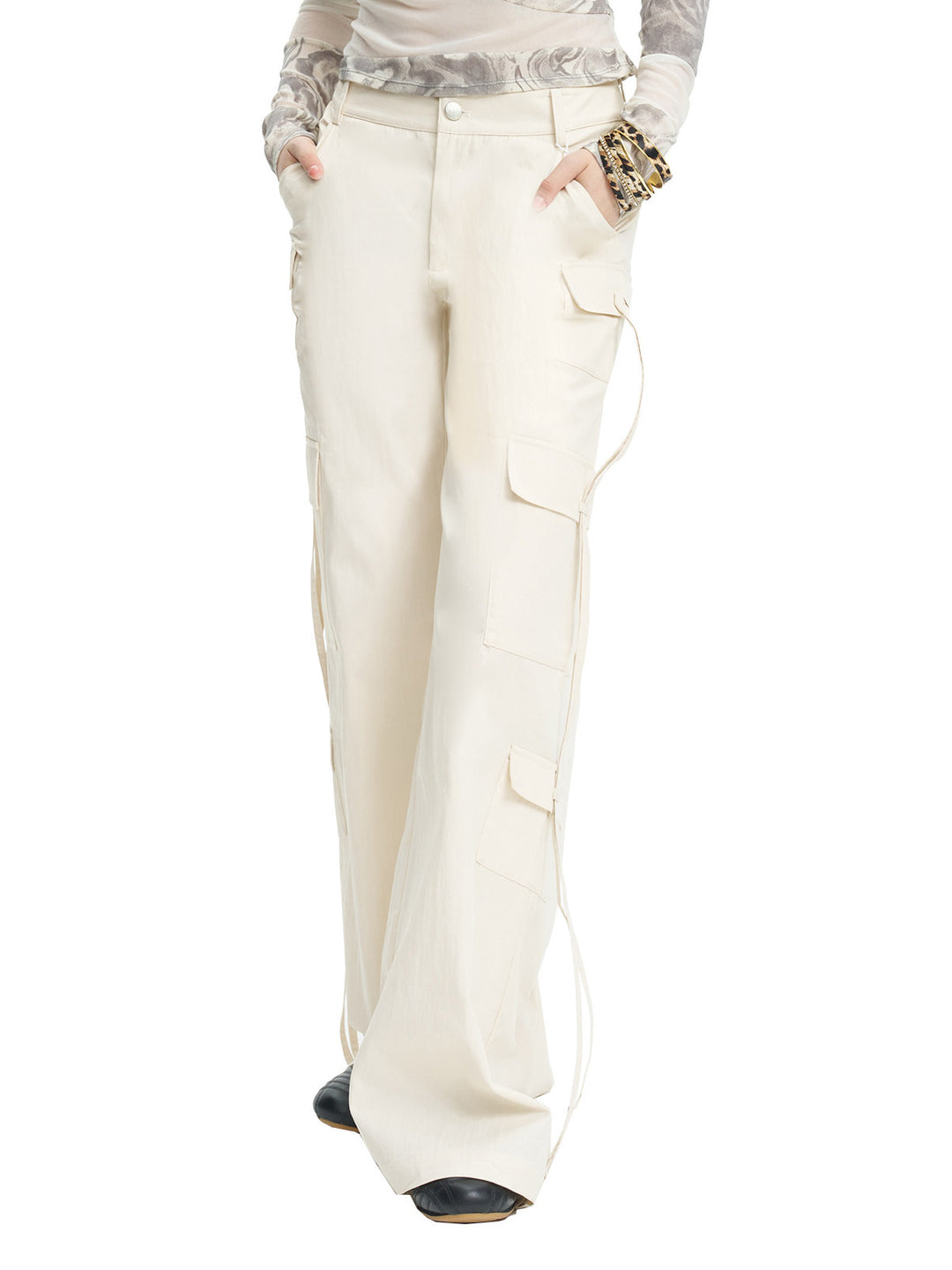 NEXT PASSPORT white drawstring multi-pocket cargo pants in white — three-quarter close studio view showing pocket placement.