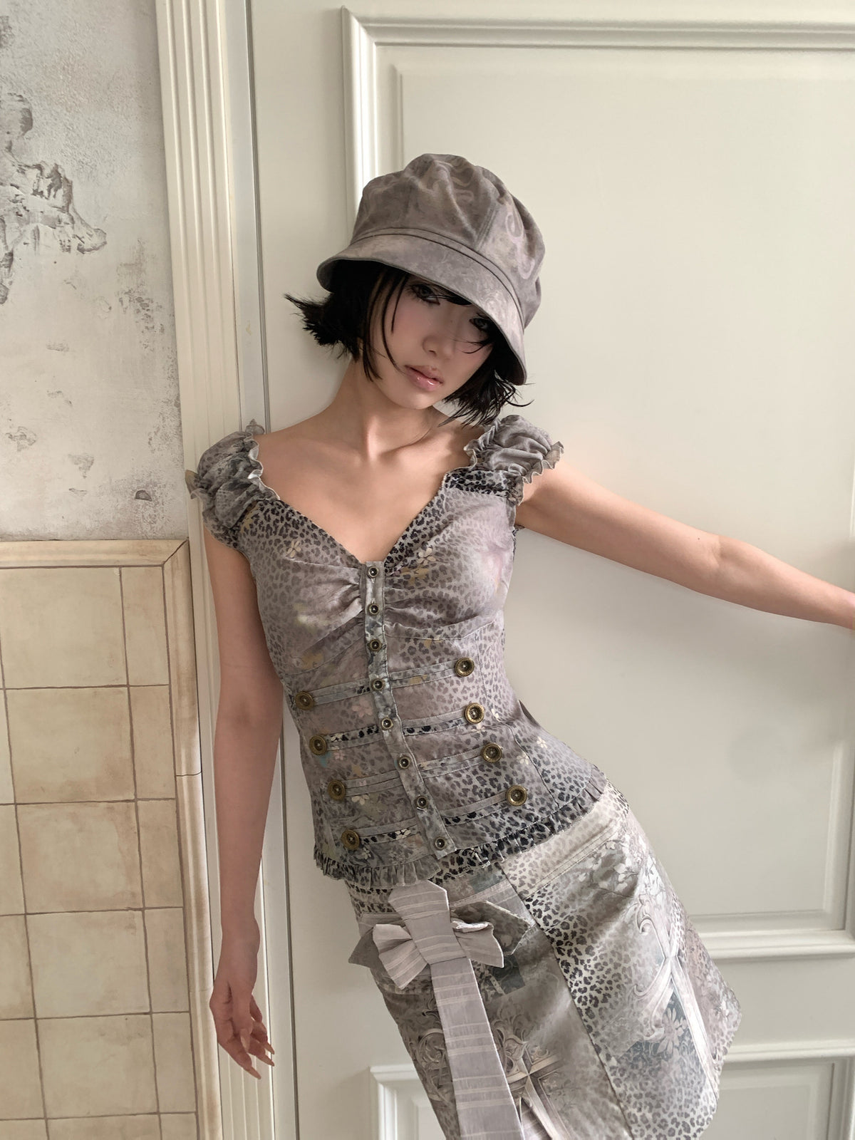 4RE1GN CROSS LEOPARD bow-detail layered skirt in beige multicolor — close modeled view with one arm extended