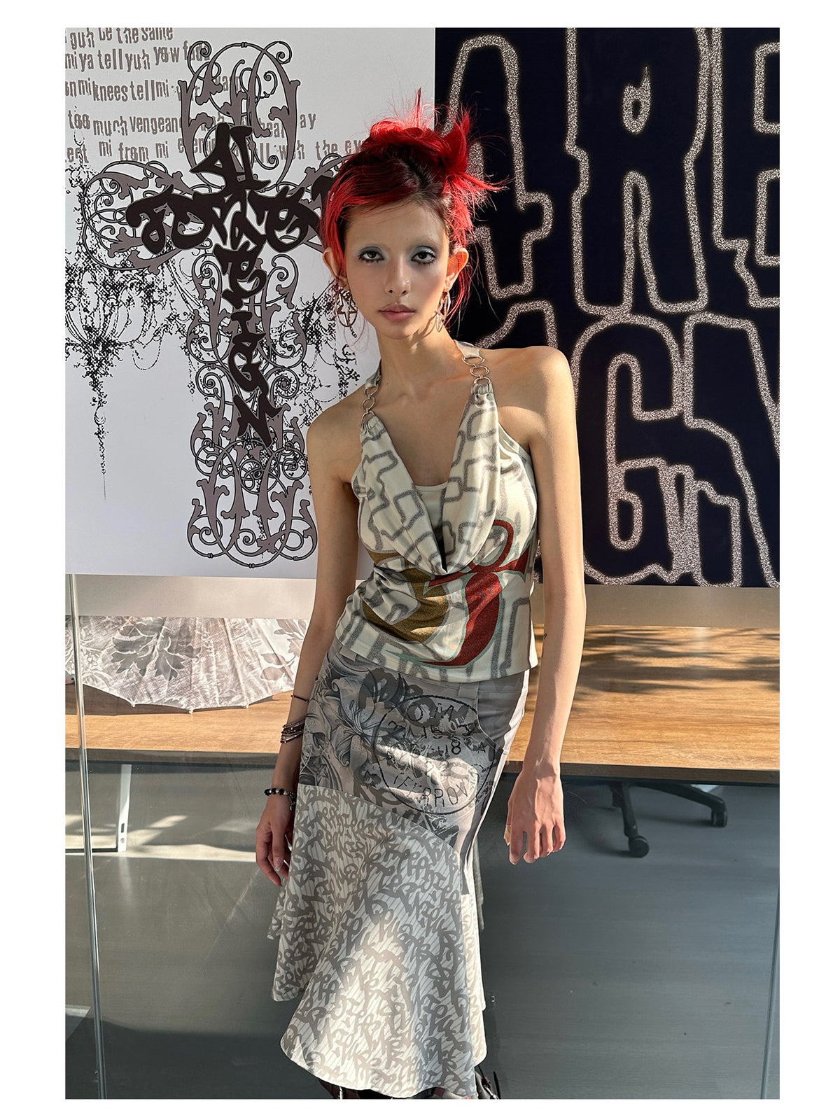 4RE1GN SIGIL cowl-neck halter top in ivory multicolor — front modeled view beside the brand display