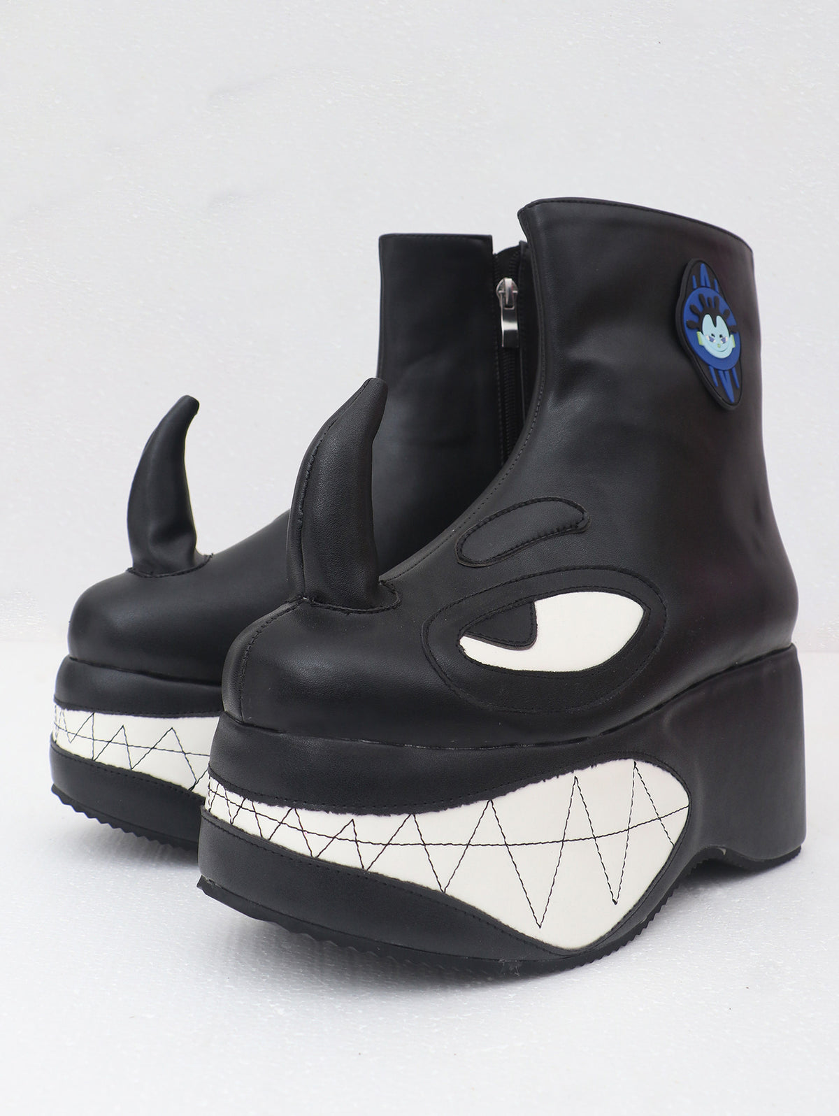 EMBRYO ANGRY horn-toe platform boots — front three-quarter detail