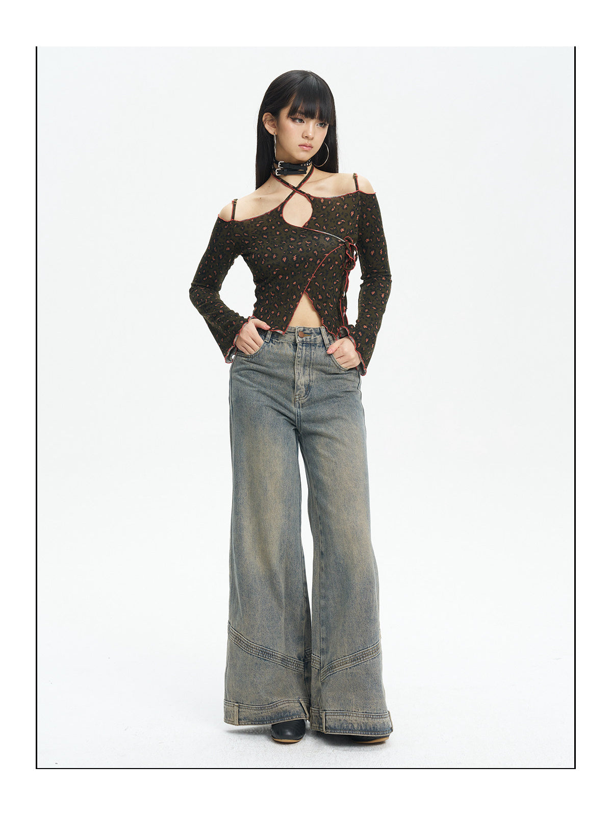 Full-length front view of the leopard knit top styled with jeans