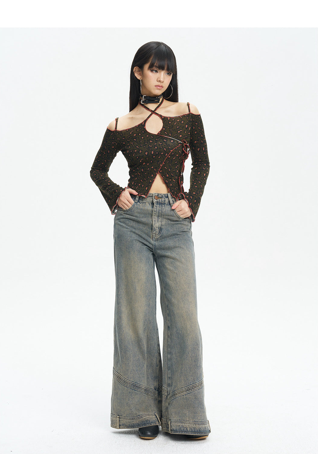 Full-length front view of the leopard knit top styled with jeans