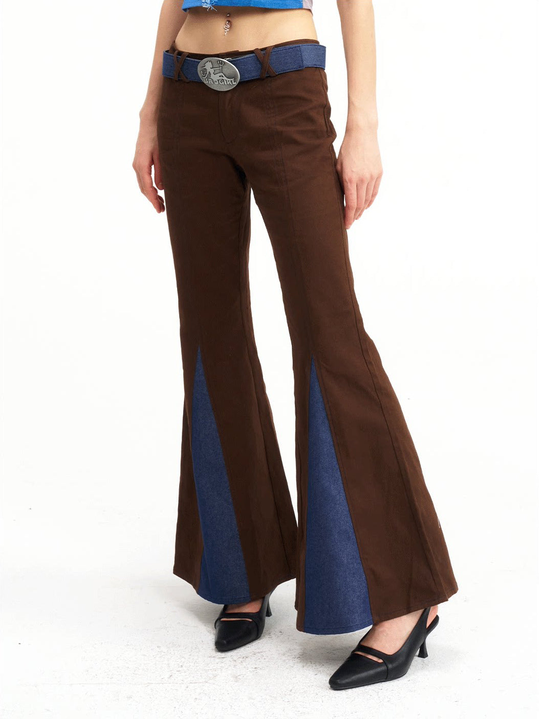 NEXT PASSPORT denim-panel low-rise flared pants in brown — waist-down angled close-up showing the triangular denim inserts.