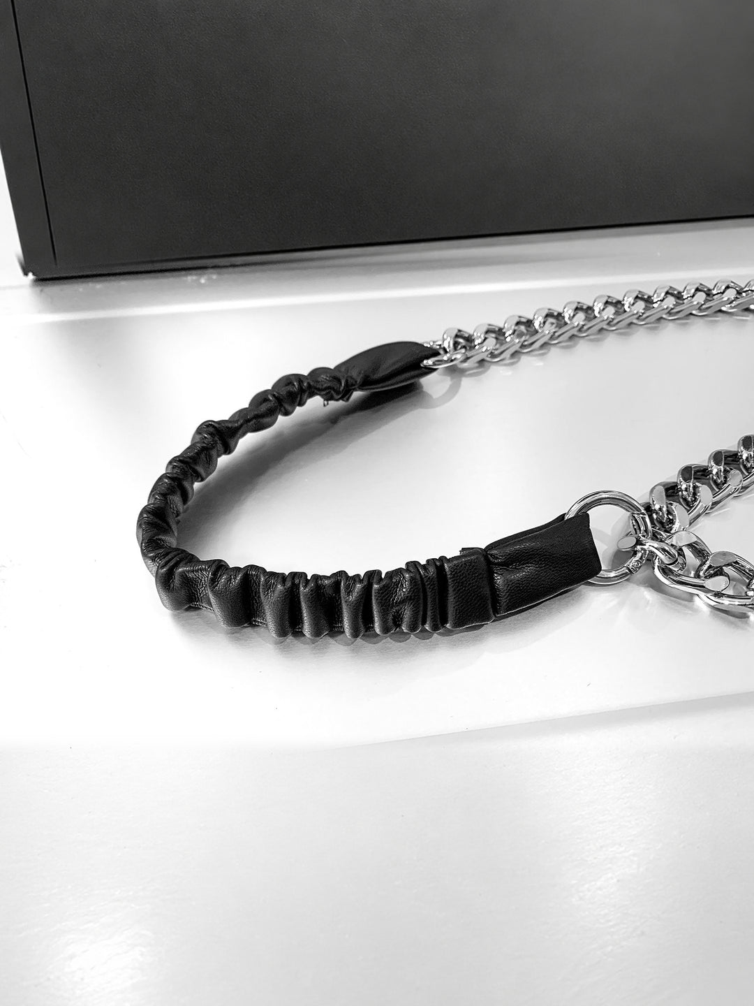 WRAVEN gathered faux-leather curb-chain belt — gathered strap texture and round connector attachment detail