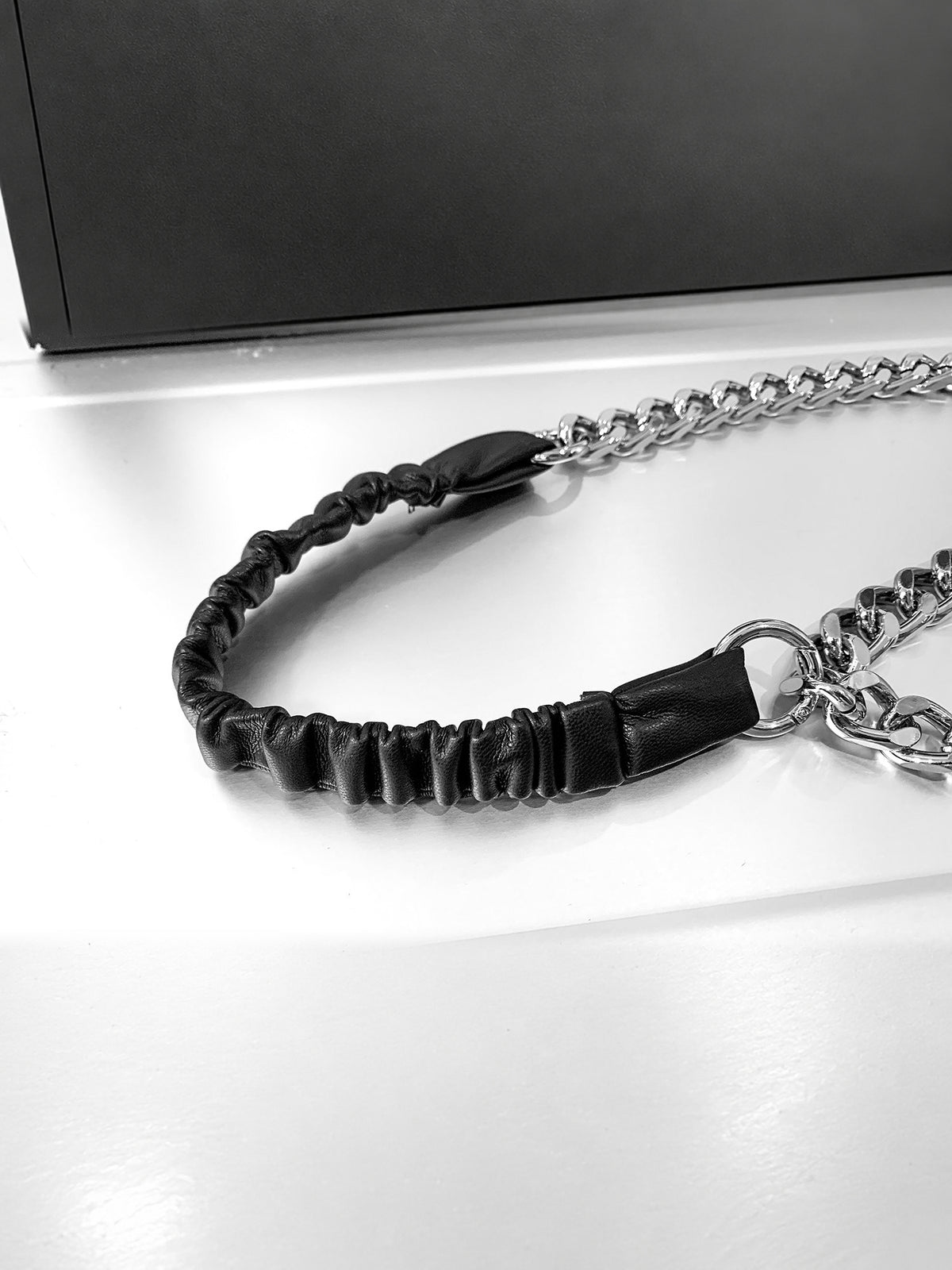 WRAVEN gathered faux-leather curb-chain belt — gathered strap texture and round connector attachment detail