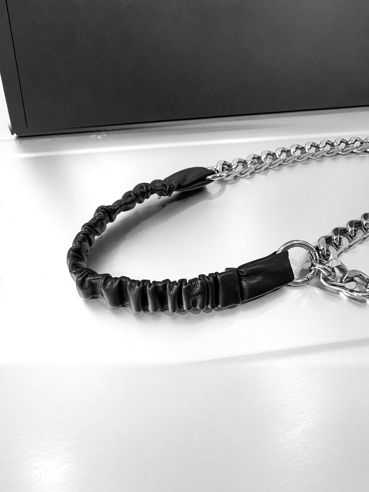 WRAVEN gathered faux-leather curb-chain belt — gathered strap texture and round connector attachment detail