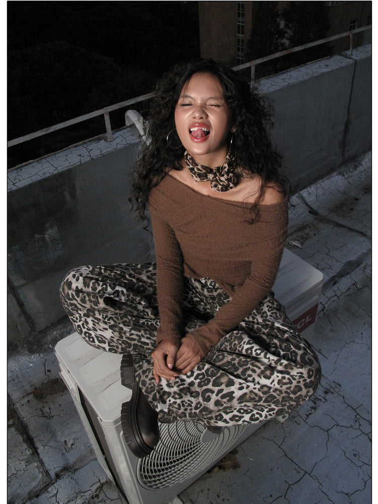 NEXT PASSPORT dark-brown twisted off-shoulder long-sleeve tee, rooftop seated pose