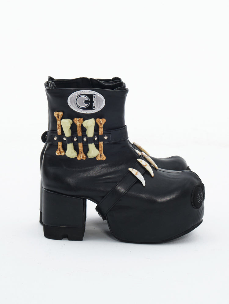 EMBRYO BONE LIFT detachable-bone platform boots — inner side view showing the removable bone details and fastening straps