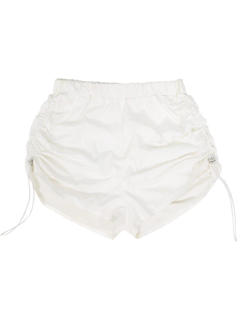 NEXT PASSPORT side-ruched drawstring mini shorts in white, flat lay