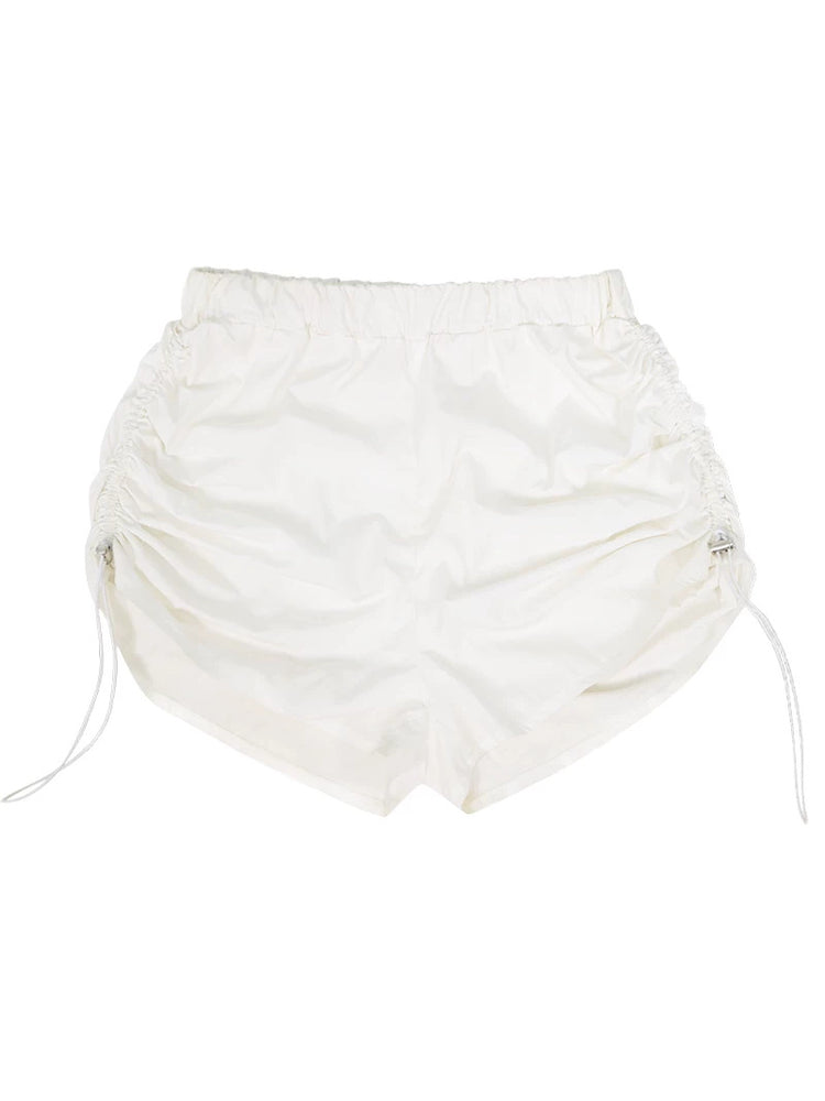 NEXT PASSPORT side-ruched drawstring mini shorts in white, flat lay