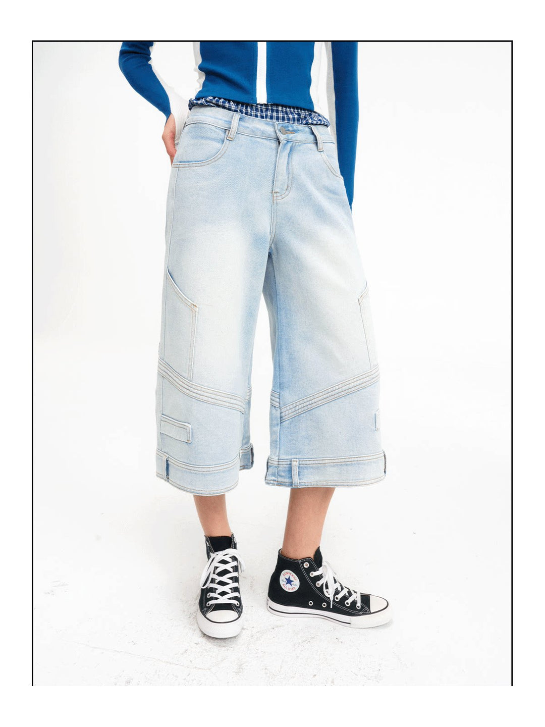 Close front view showing the layered plaid waist and wide legs