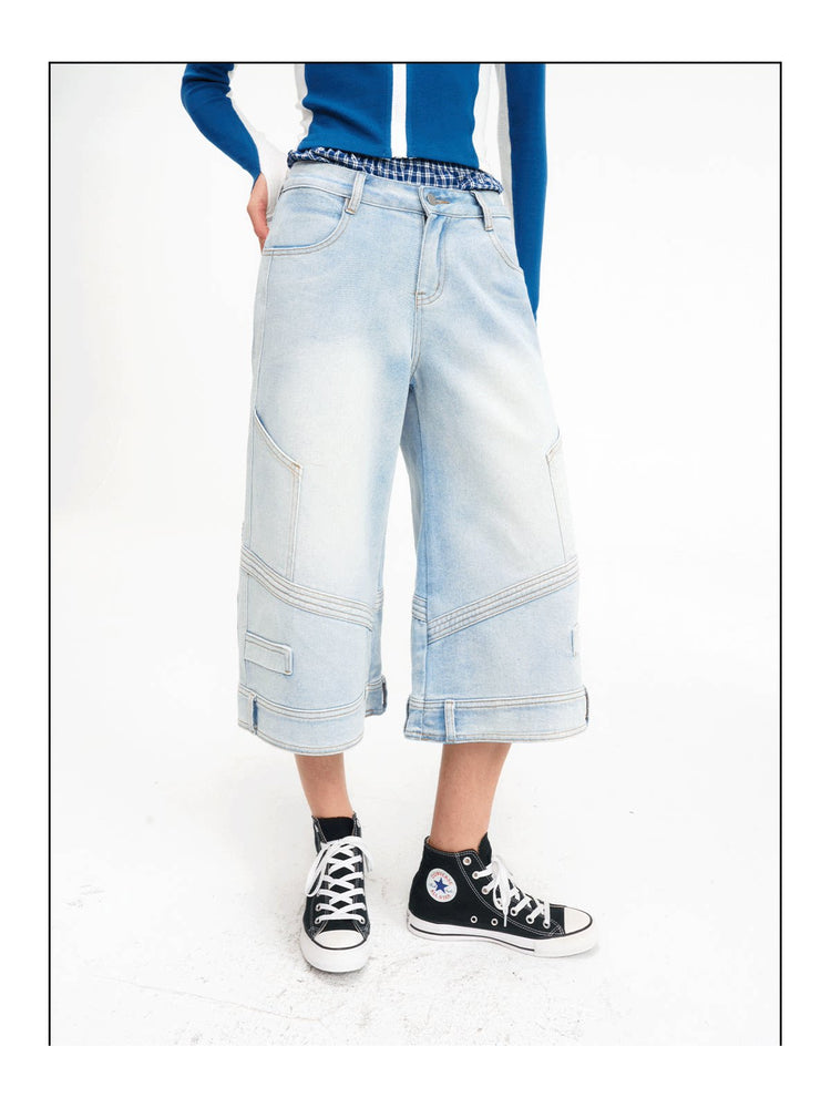 Close front view showing the layered plaid waist and wide legs