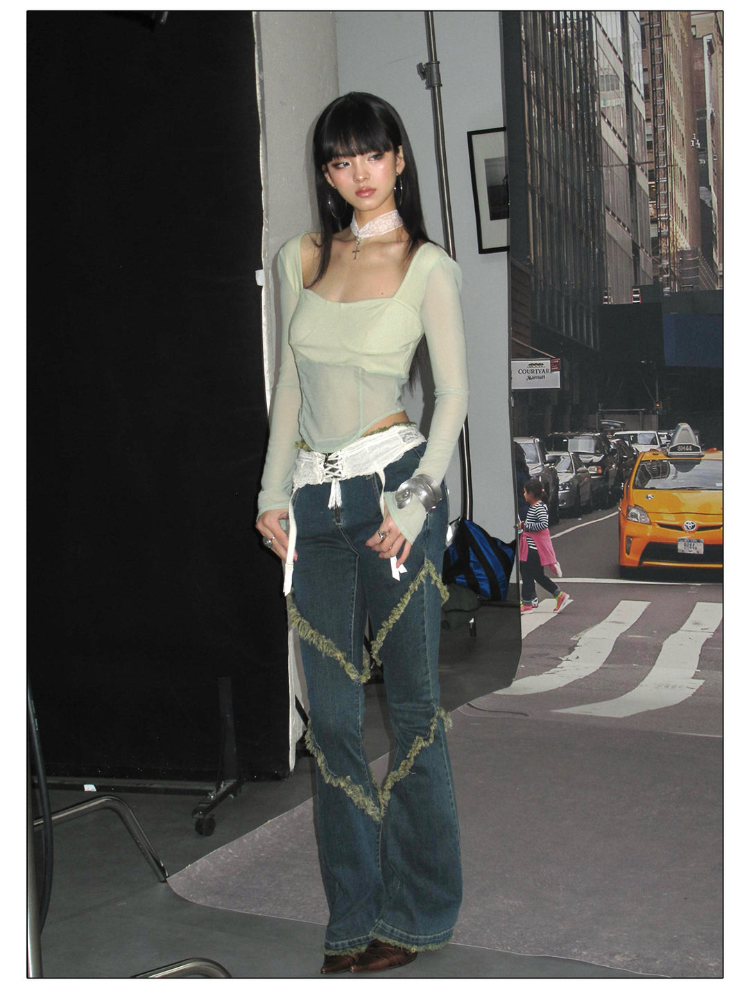 NEXT PASSPORT deep-blue frayed-hem slim flare jeans in denim blue — straight-on environmental modeled view.