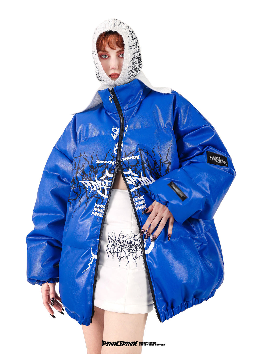 PINKSPINK ELECTRIC THORN embroidered knit balaclava in white — front modeled view with one hand on the hip and a blue puffer