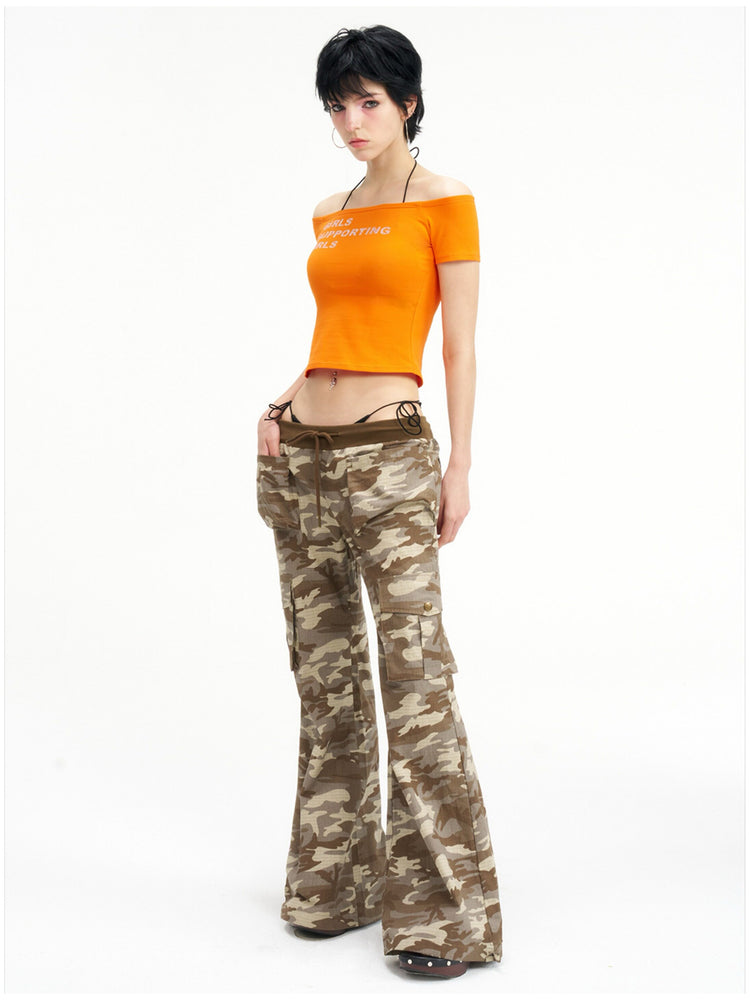 NEXT PASSPORT GIRLS SUPPORTING GIRLS rhinestone off-shoulder crop tee — orange full-body modeled front view on white.