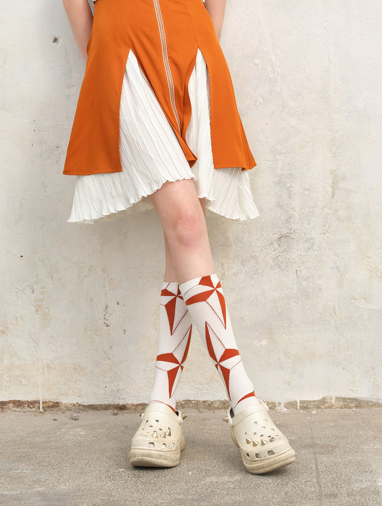 NEXT PASSPORT orange-white argyle lace-up mid-calf socks close-up view