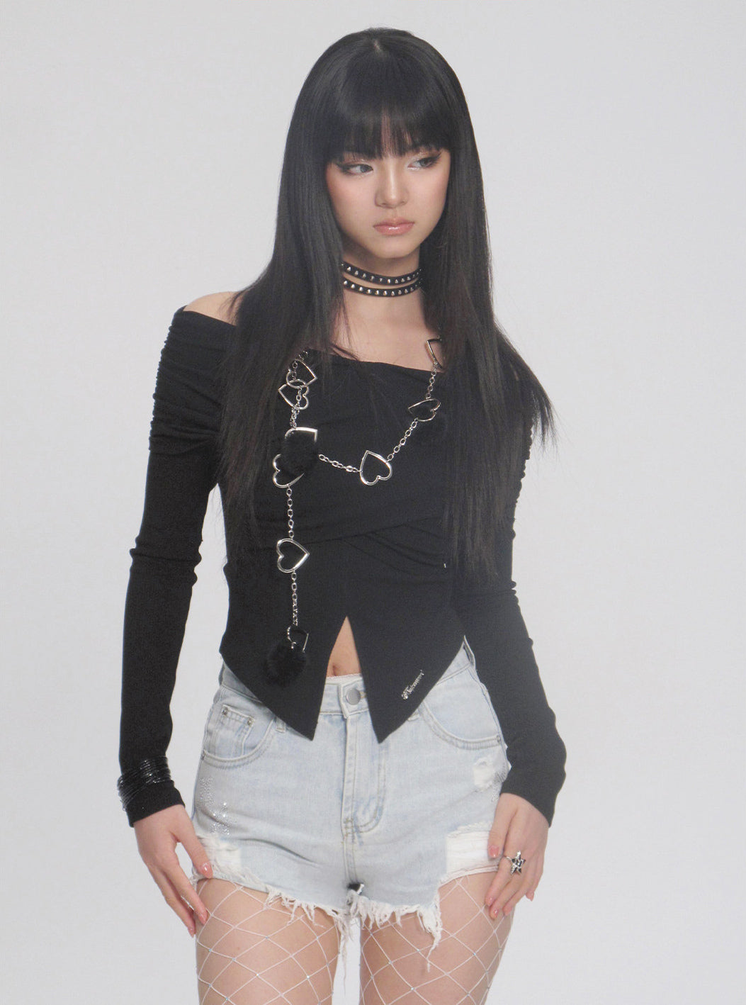 NEXT PASSPORT distressed fringe denim shorts in denim blue — close front modeled view emphasizing the fringe hem.