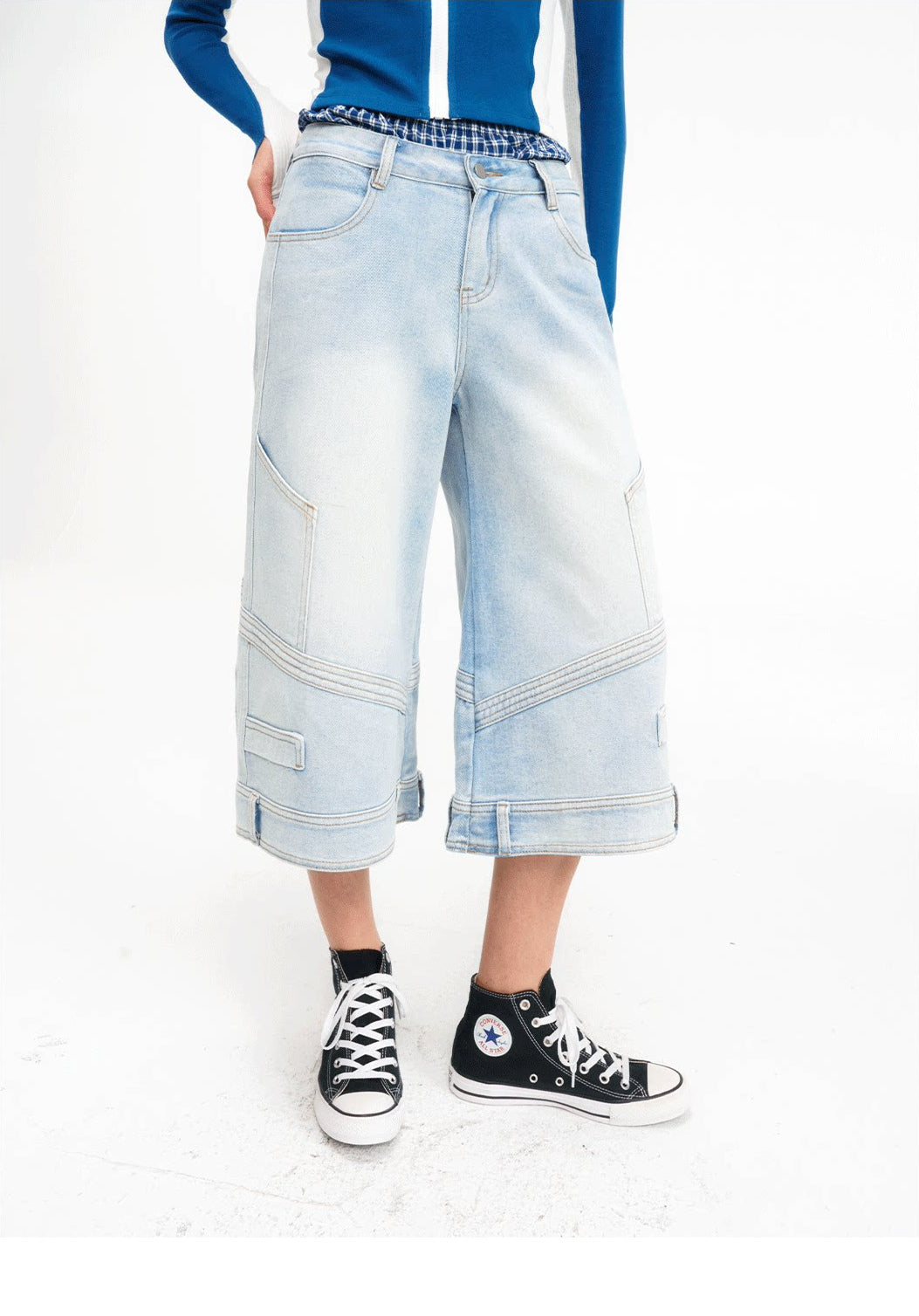 Close front view showing the layered plaid waist and wide legs