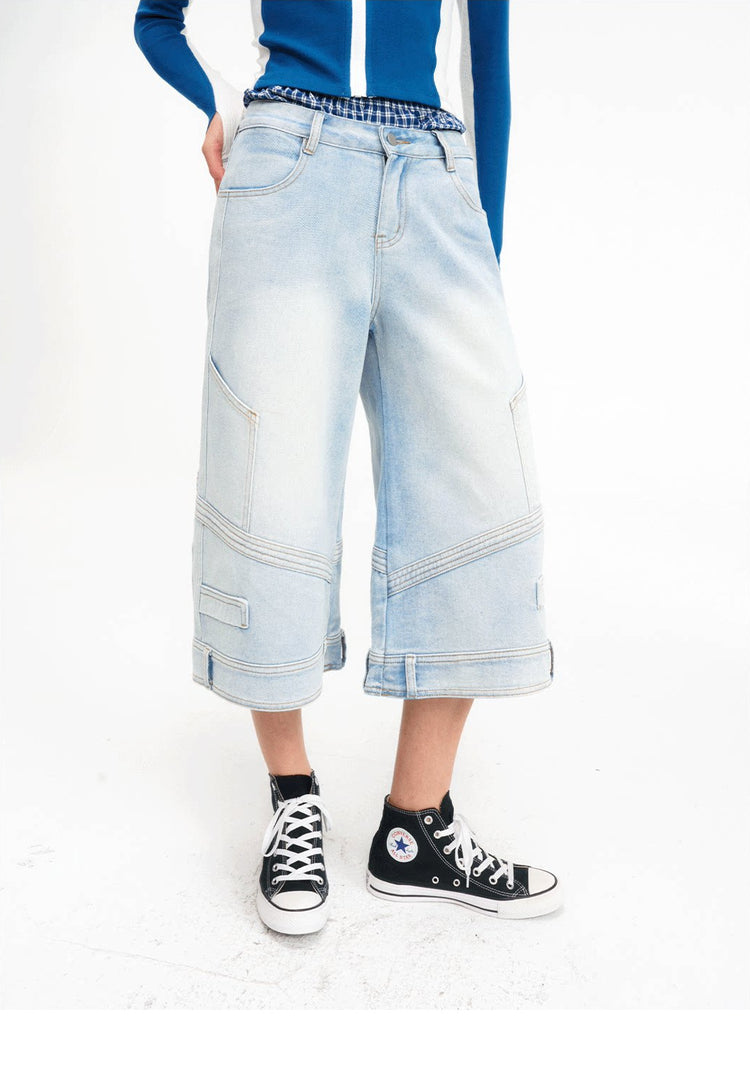 Close front view showing the layered plaid waist and wide legs