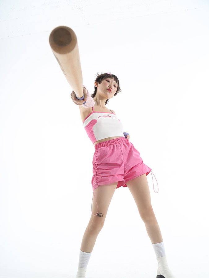 NEXT PASSPORT side-ruched drawstring mini shorts in pink, studio front view