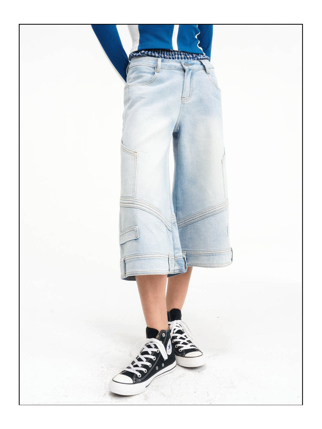 Close three-quarter view of the cropped wide-leg denim construction
