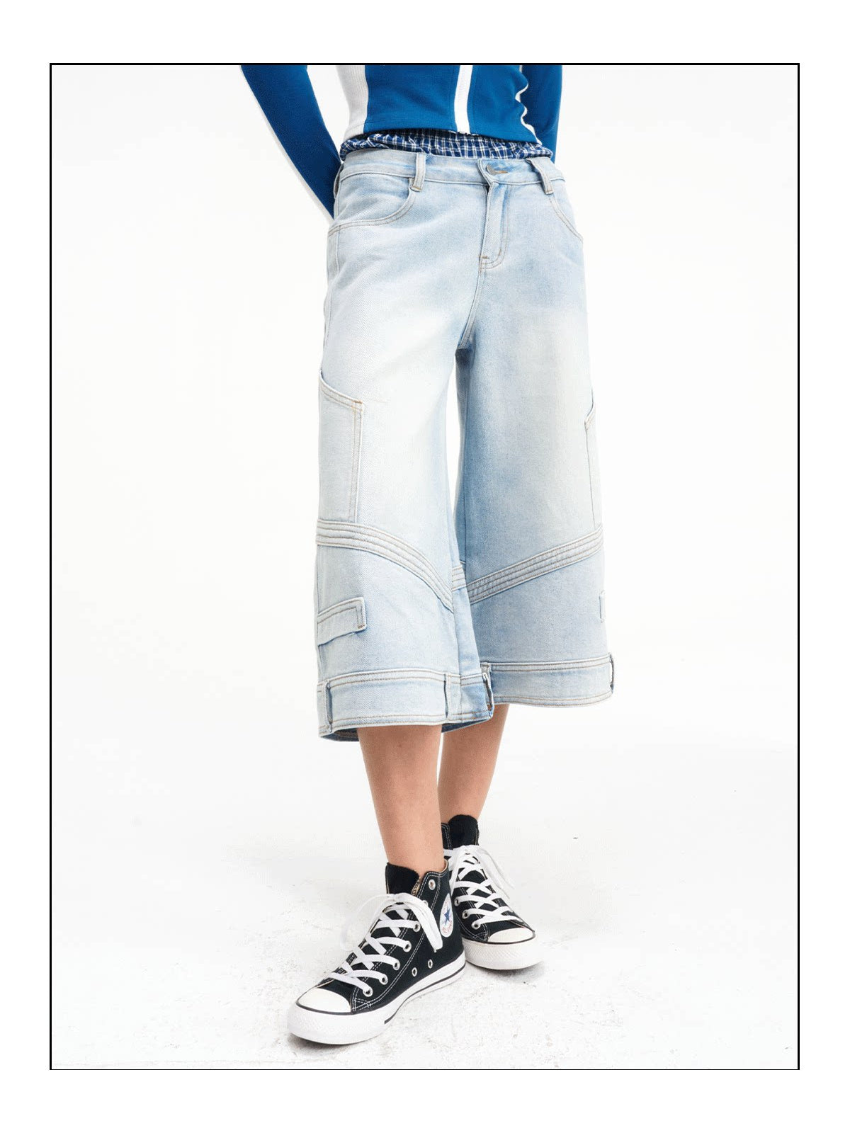 Close three-quarter view of the cropped wide-leg denim construction