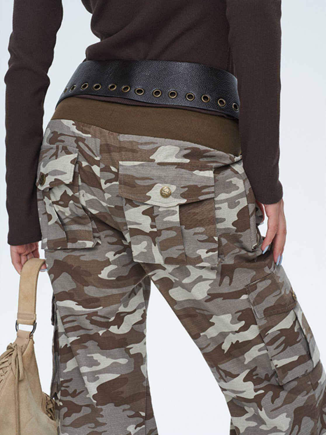 NEXT PASSPORT camouflage ribbed-waist flared pants — close-up of the rear waistband and cargo pockets.