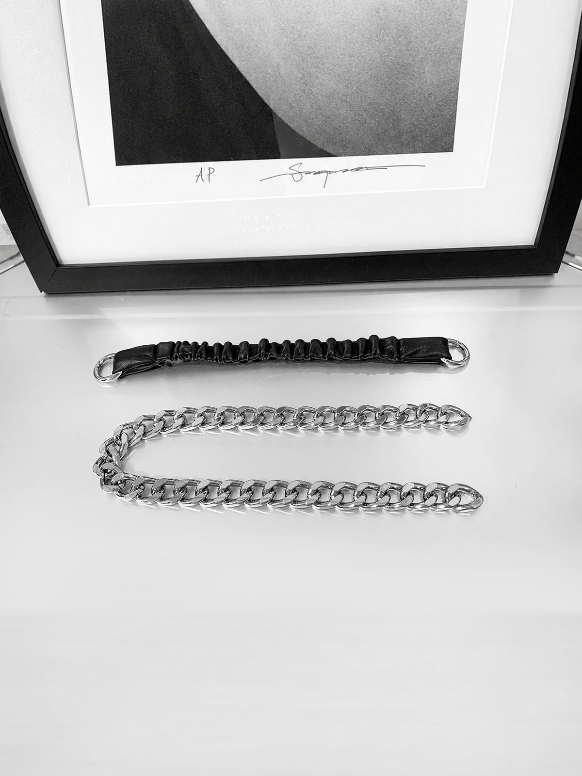 WRAVEN belt with the silver-tone curb chain detached from its black gathered faux-leather strap and round connectors.