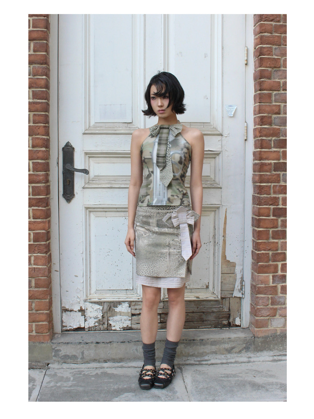4RE1GN CROSS LEOPARD bow-detail layered skirt in beige multicolor — full-length front modeled view in a doorway