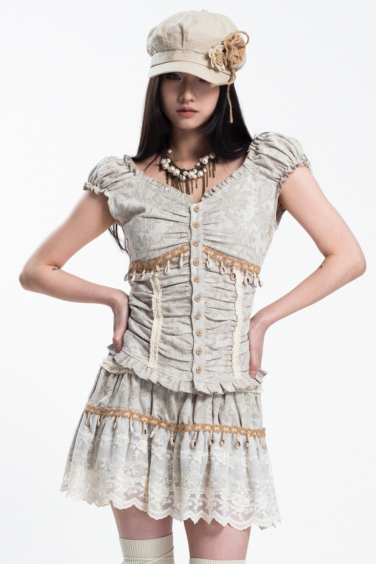 4RE1GN SHELL jacquard blouse and lace skirt separates in ivory — front studio modeled view with hands at the waist