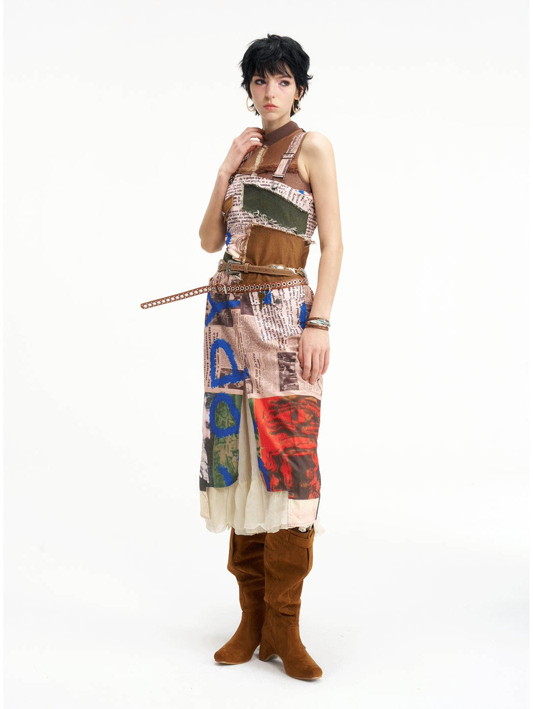 NEXT PASSPORT newspaper-print slit suspender dress — front view with extended waist strap.