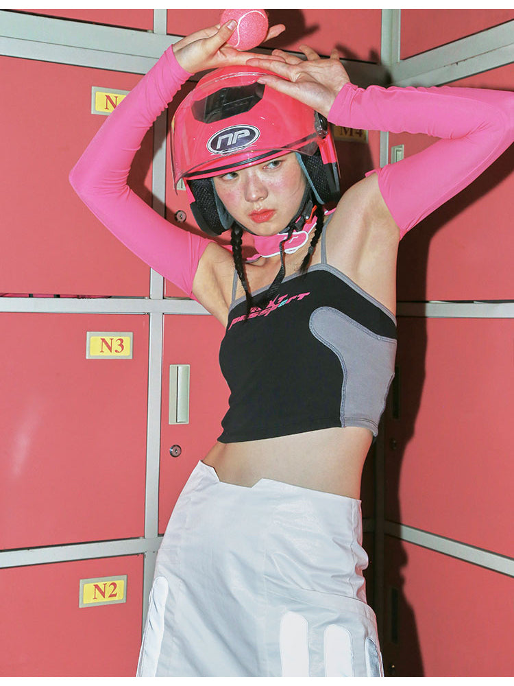 NEXT PASSPORT RETROFUTURE color-block crop camisole — black modeled front view with helmet styling and contrasting curved panels.