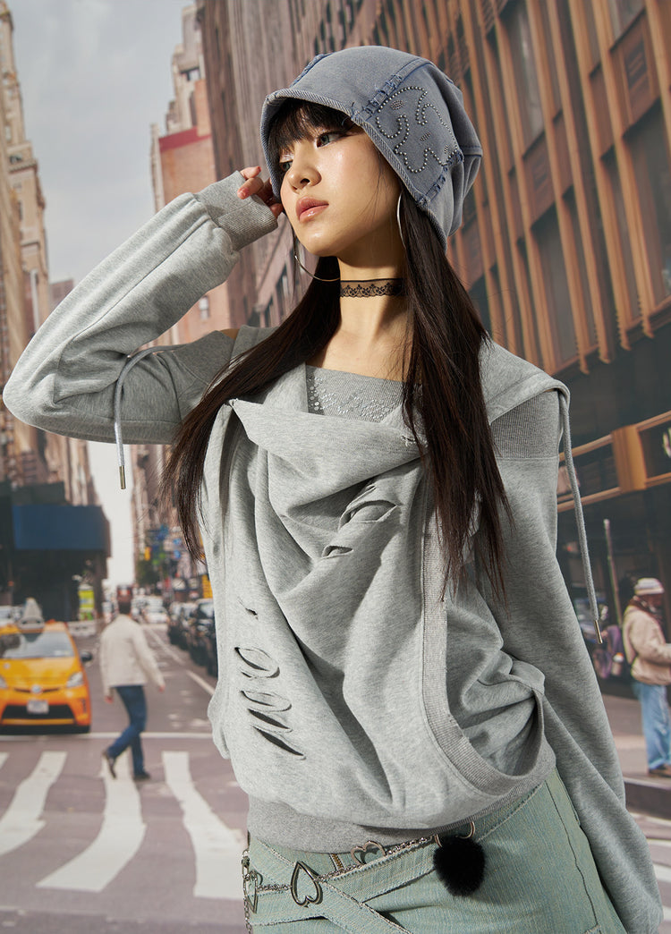 Outdoor modeled view of the gray distressed hoodie