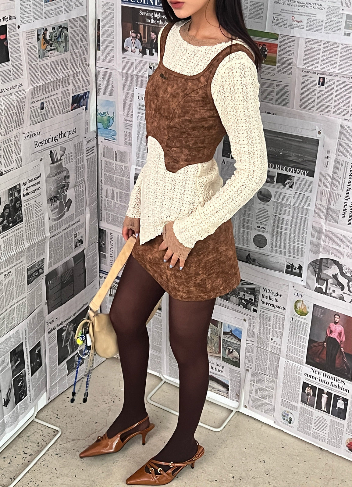 NEXT PASSPORT wasteland-brown shark-pleat vest and mini skirt — styled front view