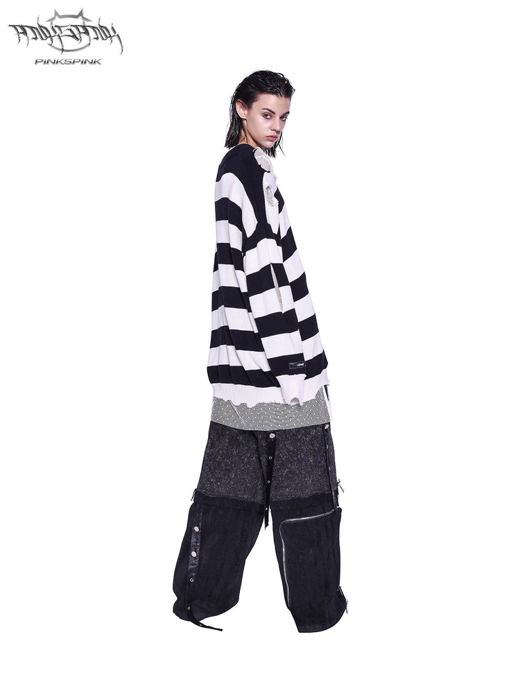 PINKSPINK ELECTRIC MOON distressed striped sweater in BLACK WHITE STRIPE — full-body side view styled with dark cargo trousers.