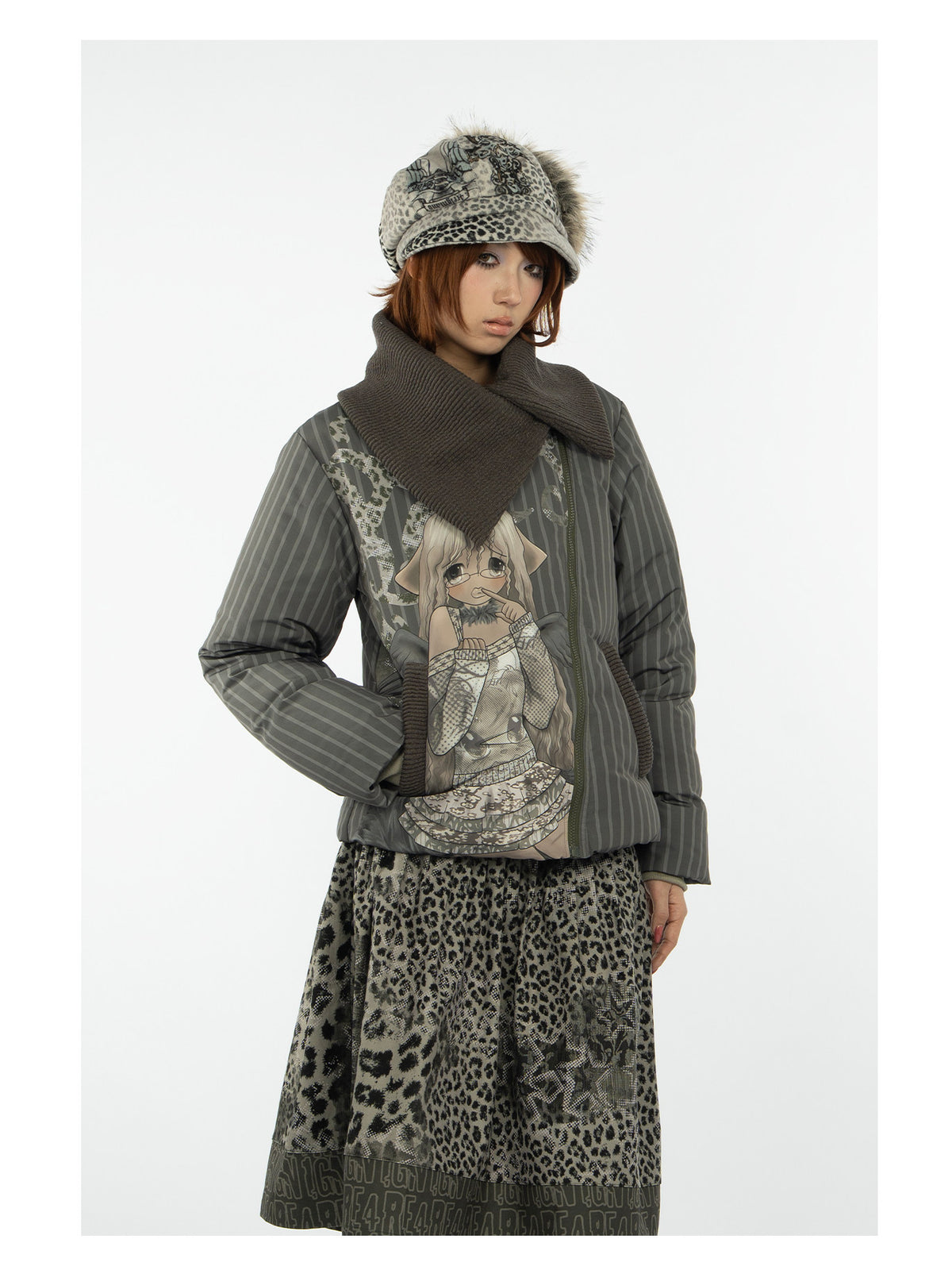 4RE1GN COMIC STRIPE asymmetric-collar down jacket in olive green — close modeled view styled with a leopard-print skirt