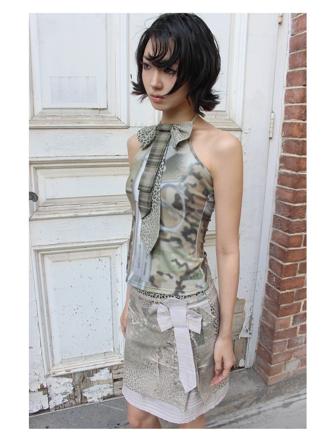 4RE1GN CROSS LEOPARD bow-detail layered skirt in beige multicolor — close three-quarter modeled view showing the bow