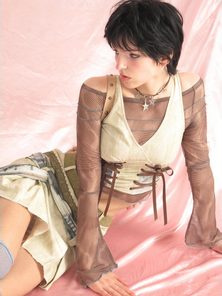 Seated studio detail of the vest and matching mini skirt